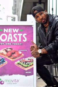 Social media influencer posing in front of sign