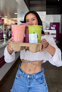 Social media influencer holding smoothies