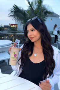 Social media influencer holding smoothie